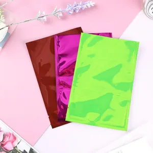 Nahaufnahme farbiger aluminisierter Flachbeutel in Rot, Violett und leuchtendem Neongrün