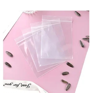 Set of transparent PE ziplock plastic packaging bags on a pink decorative background.
