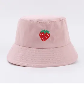 Close-up detail of a cute pink bucket hat featuring delicate embroidered strawberry pattern.