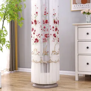 Detailed view of white vertical air conditioner cover featuring elegant red plum embroidery.