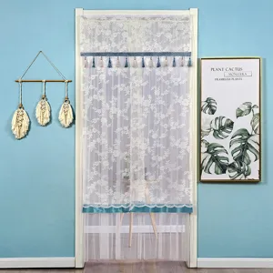 White lace door curtain detail, elegant floral pattern with blue tassel and satin trim.