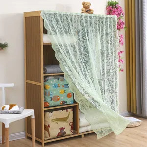 Close-up of the light green lace cabinet curtain, showing delicate patterns on storage shelves.