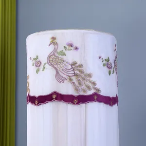 Vertical air conditioner dust cover detail, white mesh fabric with elegant purple peacock embroidery design.