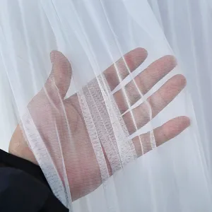White mesh curtain detail showing fine texture, breathable fabric, and good light transmission.