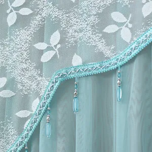 Close-up detail of double layer sheer door curtain, white leaf mesh, cyan lace, beads.