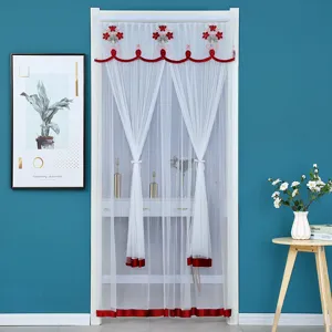 Detailed view of white sheer door curtain featuring elegant red floral embroidery and border.