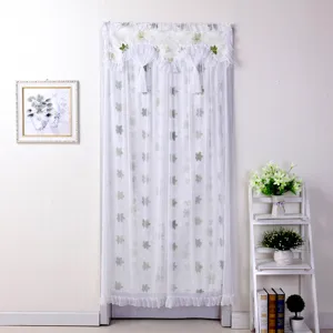 White double-layer door curtain detail featuring delicate leaf patterns, ruffles and white tassels.