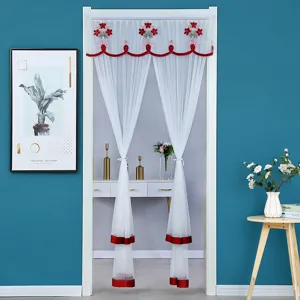 White sheer door curtain with red floral embroidery and trim, ideal for summer decor.
