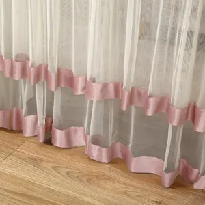 Detailed view of white sheer curtain featuring elegant pink satin trim at the bottom edge.