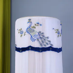 Vertical cylindrical air conditioner dust cover with elegant blue peacock embroidery.