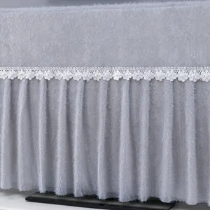 Details of the elegant gray plush TV dust cover featuring delicate white daisy lace and pearls.