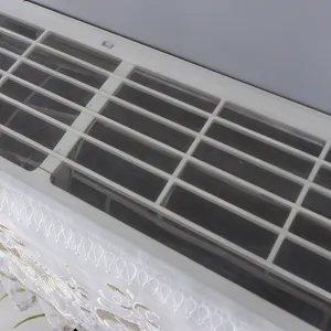 Detail shot of a white wall-mounted air conditioner dust cover with delicate lace trim.