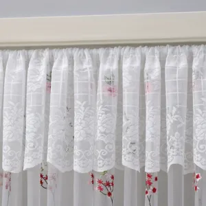 White lace curtain detail showing delicate floral embroidery and sheer mesh texture.