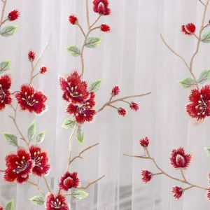 Exquisite red floral embroidery detail on white sheer curtain fabric, elegant home decor.