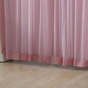 Pink sheer curtain close up detail showing soft fabric texture and neat hemline finish.