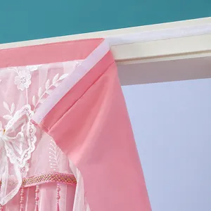 Primer plano de cortina de encaje rosa con exquisito bordado y práctico sistema de velcro.