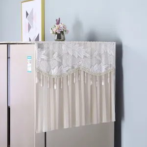 White lace refrigerator dust cover with floral embroidery and hanging bead fringe decor.