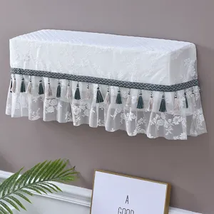 Weißer Spitzen-Wand-Klimaanlagen-Staubschutz mit eleganten Quasten für die Heimdekoration.