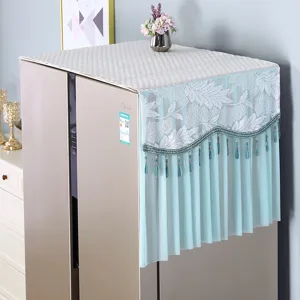 Detailed view of elegant lace refrigerator dust cover with hanging beads, fabric top protector.