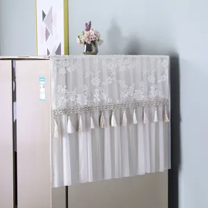 White lace refrigerator dust cover with floral embroidery and stylish tassels for kitchen home decor.