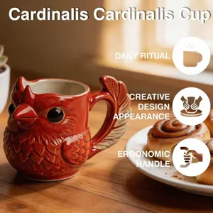 Detail of red cardinal bird ceramic mug featuring creative feather-shaped handle design.