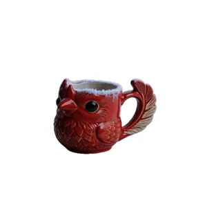 Red cardinal bird shaped ceramic coffee mug with unique feather handle and snow rim.