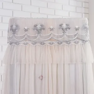 Elegant lace dust cover for vertical air conditioner with exquisite embroidery and mesh.