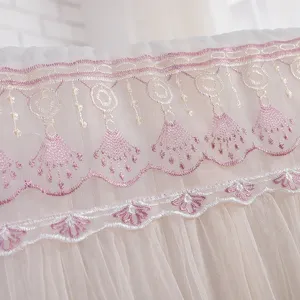 Lace air conditioner cover detail, featuring delicate pink embroidery and tassels on soft mesh fabric.