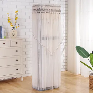 Detailed view of elegant white lace vertical air conditioner dust cover in home living room.