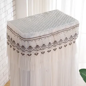 Detailed view of embroidered lace vertical air conditioner dust cover with quilted top.