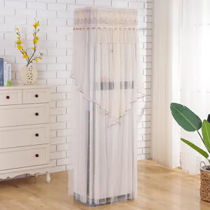 Detailed view of beige lace vertical air conditioner dust cover in home living room decor scene.