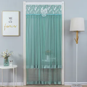 Green lace door curtain detail, elegant floral embroidery, white bow and chic tassels for decor.