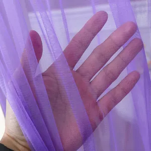 Detail view of purple mesh curtain fabric, showing soft texture and high sheerness.