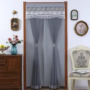 Grey door curtain detail showcasing exquisite white lace and pleated gauze design in room decor.