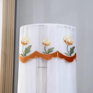 Vertical air conditioner cover detail showcasing exquisite embroidered floral mesh fabric.