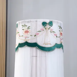 Vertical cylindrical air conditioner dust cover with elegant floral embroidery and green bow trim.