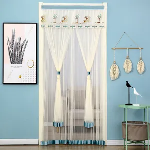 Scene detail of sheer door curtain featuring elegant deer embroidery and blue velvet trim.