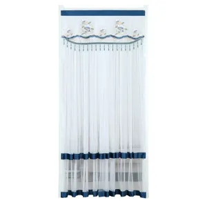 White sheer door curtain with blue trim, floral embroidery, and beaded fringe for home decor.