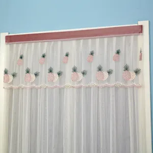 Detailed view of sheer mesh curtain featuring cute pink pineapple embroidery and velvet header.