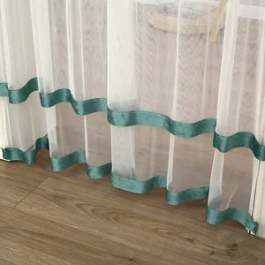 Sheer white window curtain with green velvet trim details, elegant interior decoration fabric.