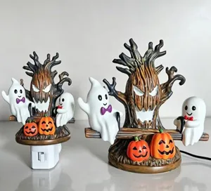 Detail view showing two styles of Halloween ghost and spooky tree resin night lights