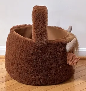 Detail view of brown plush highland cow Easter basket showing its soft furry texture and handle