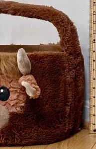 Close-up detail showing the size of the brown plush highland cow Easter basket