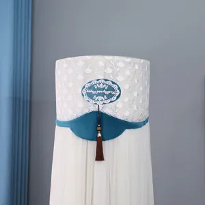 Cylindrical floor standing air conditioner cover detail, white lace mesh and blue velvet fabric.