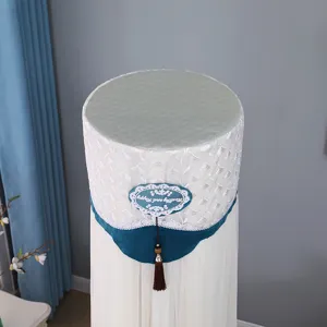 Vertical cylindrical air conditioner cover with delicate lace embroidery and tassel decor.
