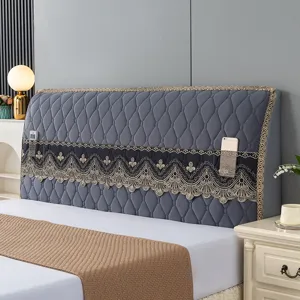 Quilted gray headboard cover detail showing exquisite lace trim and handy storage pocket.