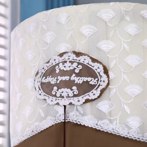 Cylindrical air conditioner dust cover detail featuring delicate white lace embroidery on cream mesh.