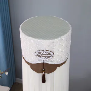 Vertical cylindrical air conditioner dust cover with elegant green top and tassel trim.