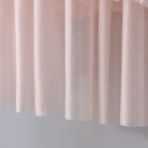 Pink lace mesh fabric detail of air conditioner dust cover, soft texture close up.