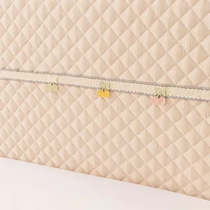 Thicken headboard cover detail shot, quilted diamond pattern with cherry lace trim.